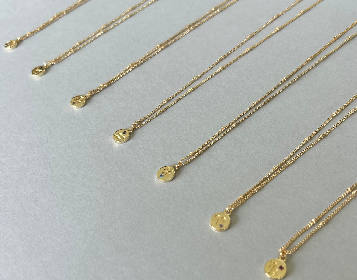 RUMI gold plated Zodiac necklaces with round star sign pendants and coloured accents